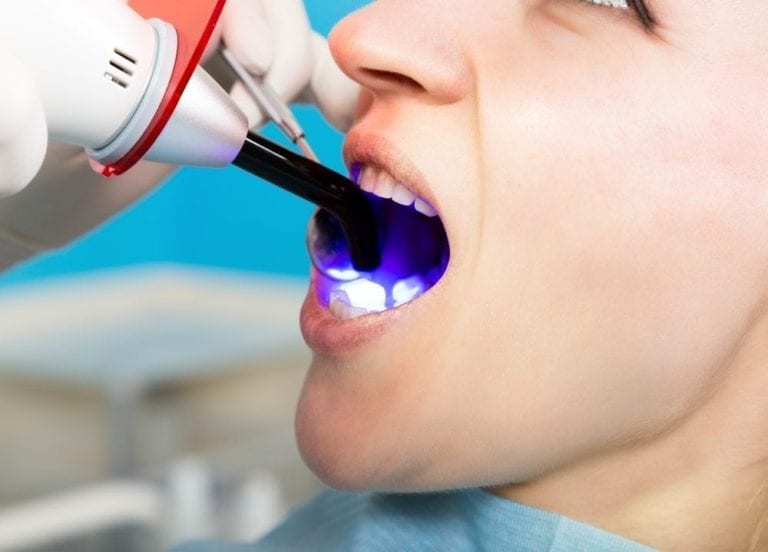 Doctor examines the oral cavity on tooth decay